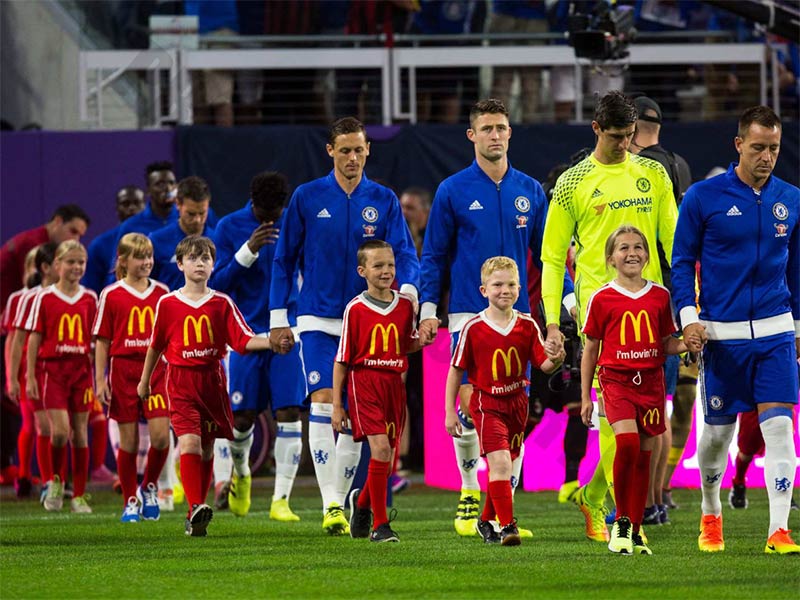 Why do soccer players walk out with kids?