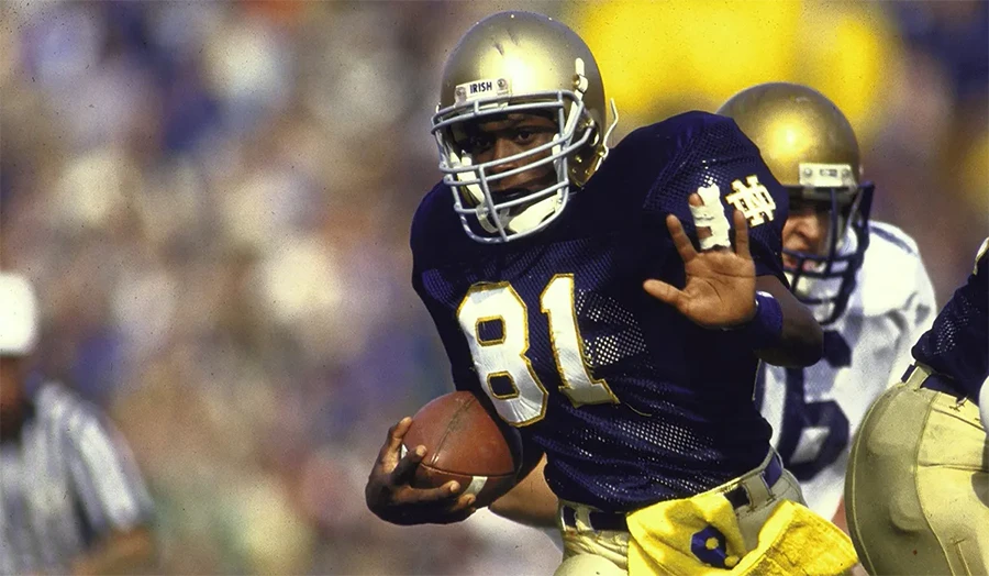 Tim Brown catching a pass and sprinting toward the end zone for Notre Dame